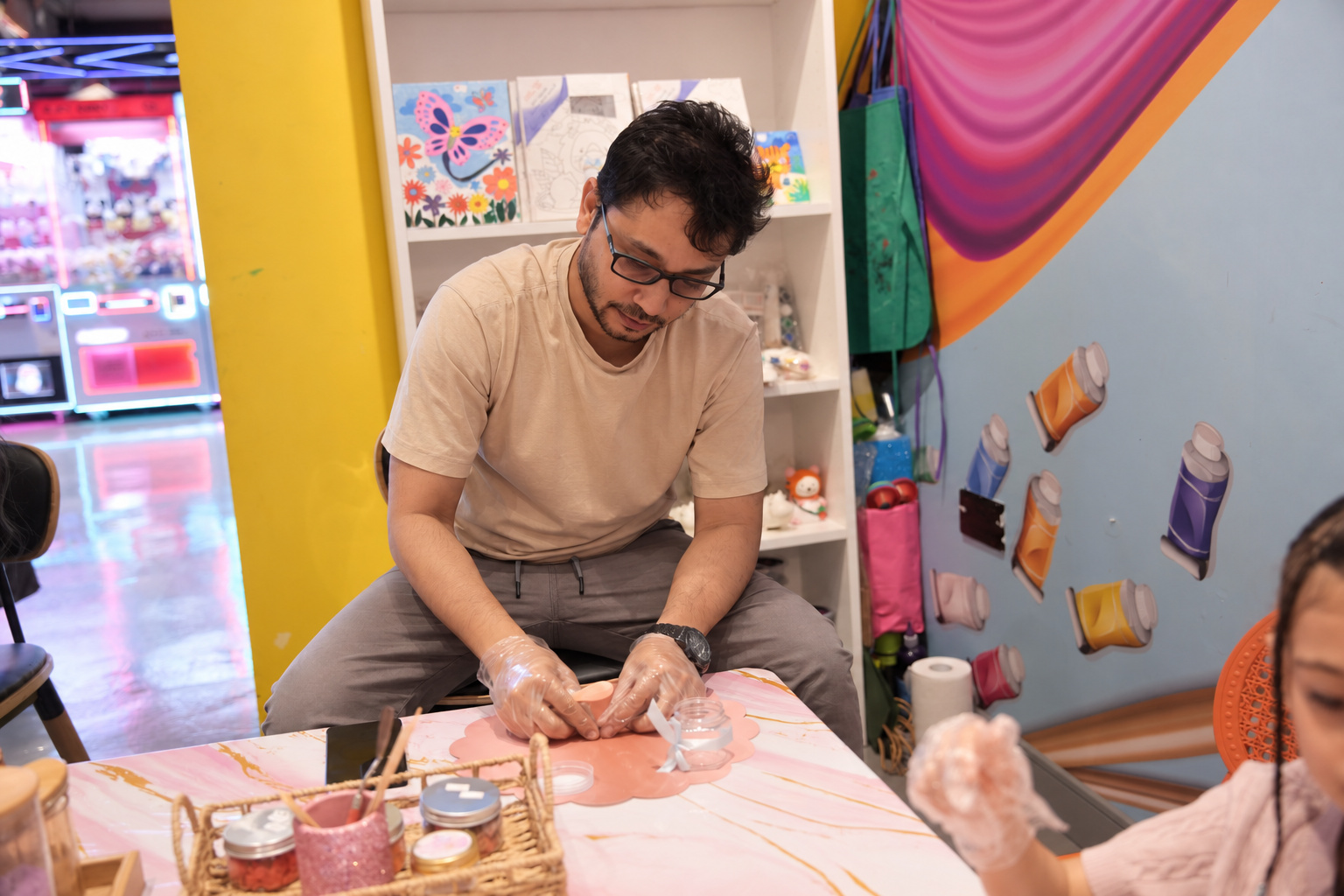 A guest making a DIY creation at the Black Bunny workshop table
