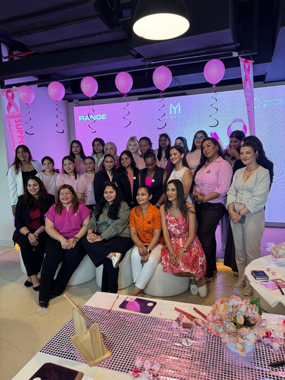 A large group of colleagues at a corporate Earthy Elegance DIY beauty station