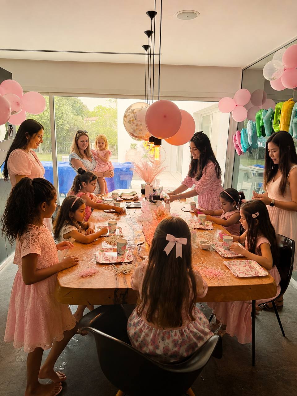 Kids and parents personalising their own creations around the table at an Earthy Elegance birthday DIY party