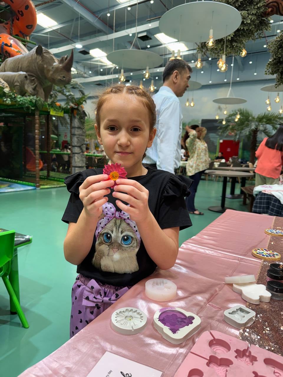 A child with a handmade flower soap at the Black Bunny DIY studio